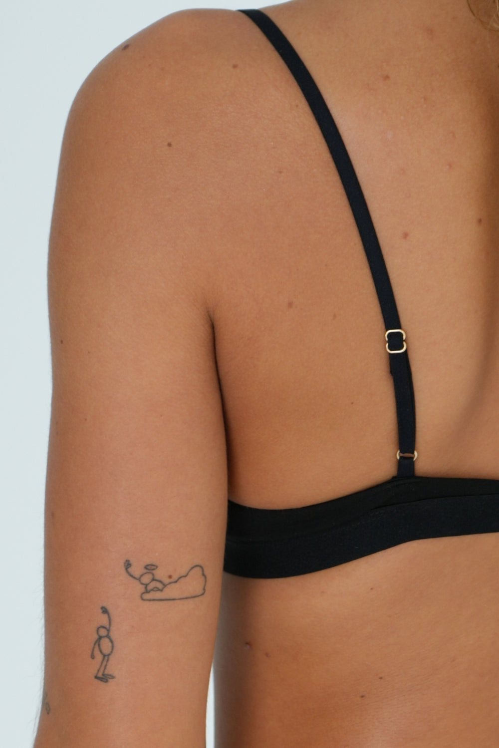 Woman wearing flattering and comfortable wireless triangle bralette in black bamboo natural fibre breathable fabric